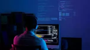 rear view of programmer working all night long